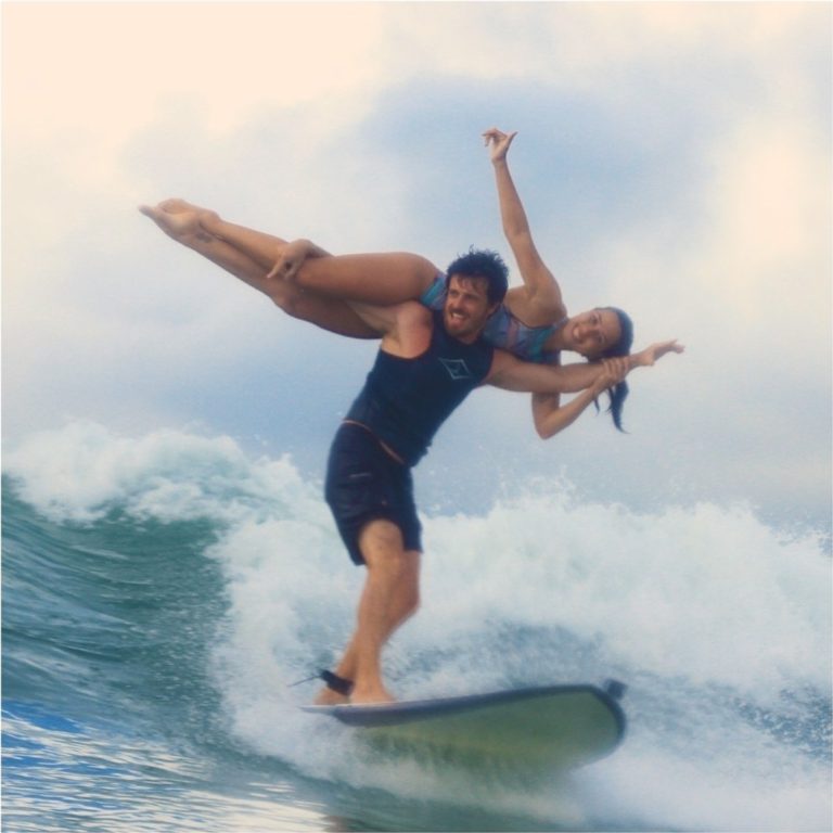 The first couple practicing tandem surfing standing on one board | 2023